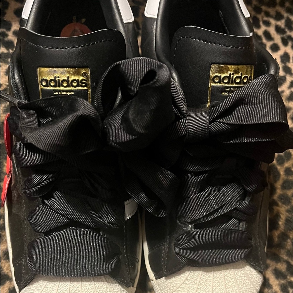 Adidas Black and White Sneakers with Gold Accents